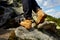 Hiking boots close-up. girl tourist steps on the mountain trail on the rocks.