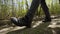 Hiking in the bright spring forest. Unrecognizable shoes close-up gimbal, steadicam smooth 4K