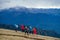 Hiking in the Caucasus Mountains. Women take a walk, climb a slope in autumn