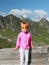 Hiking child with fox mask in the Alps