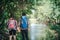 Hiking couple in forest together. Adventure travel vacation. Hap