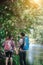 Hiking couple in forest together. Adventure travel vacation. Hap