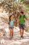 Hiking couple of hikers on trail walk trek with hike poles walking in Grand Canyon. Young Asian girl, Caucasian man, multiracial