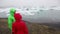 Hiking couple on Iceland Jokulsarlon glacial lagoon glacier lake. Active lifestyle tourists people walking enjoying