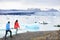 Hiking couple on Iceland Jokulsarlon glacier lake