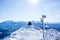 hiking couple at the summit of the snowy mountain sitting on the bench, enjoying the panorama of the swiss alps. success and