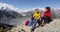 Hiking couple taking food break on alpine hike in New Zealand by Mount Cook