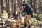 Hiking couple walking on rocks in forest wearing backpacks