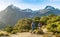 Hiking couple walking on trail at Routeburn Track in New Zealand. Hikers trekking wearing backpacks while tramping on