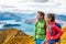 Hiking couple wanderlust adventure and travel concept with hikers relaxing looking at view. Hiking couple tramping up