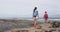 Hiking Couple Wearing Backpacks While Walking At Shipwreck Beach