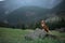 hiking with a dog. Nova Scotia Duck Tolling Retriever in the mountains, in the valley