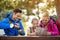 Hiking family relax sitting by the table