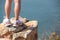 Hiking feet stand seaside rock