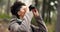 Hiking, forest and woman with binocular watch nature scenery, view or bird watching while trekking through trees