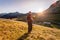 Hiking girl is enjoying the sundown in the mountains. Warm colors, alps, Austria