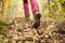 Hiking girl in a mountain. Low angle view of generic sports shoe and legs in a forest. Healthy fitness lifestyle outdoors