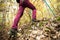 Hiking girl in a mountain. Low angle view of generic sports shoe and legs in a forest. Healthy fitness lifestyle outdoors