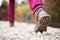 Hiking girl in nature. Low angle view of generic sports shoe and legs on pebble dirt road. Healthy fitness lifestyle outdoors