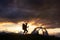 Hiking girl near tent, sunset time in mountains of Romania