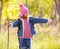 Hiking kid girl with backpack pointing finger in autum forest