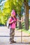 Hiking kid girl with walking stick and backpack in autumn