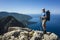 Hiking on Lycian way. Man with backpack posing for photo on rock cliff high above Mediterranean sea on Lycian Way