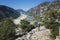 Hiking Lycian way. Man with backpack walking uphill on ancient mountain path with view of beautiful valley of Demre stream
