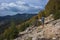 Hiking on the Lycian Way. Man is trekking on steep stony slope of covered with trees mountain, Trail from Alakilise Ruins