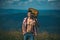 Hiking man. Motivated hiker with guitar looking at beautiful view. Trekking, travel and tourism concept. Fitness and