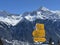 Hiking markings and orientation signs with signposts for navigating in the idyllic winter ambience of the Swiss Alps