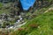 Hiking in the Monviso valleys between streams, waterfalls and flowery pastures