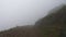 hiking in the mountains in fog, subjective view, hiking in cloudy weather, day