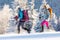 hiking in the mountains on snowshoes. two girls with backpacks go hiking in the snow. Travel and adventure concept
