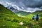 Hiking in the mountains. Tourists with backpacks in mountain. Trekking in Svaneti region, Georgia. Two men hike in mount trail.