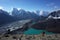 Hiking in Nepal Himalayas, Male tourist walking up to Gokyo Ri with view of Gokyo lake, Gokyo village, Ngozumba glacier