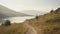 A hiking path through hills and a lake