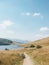 A hiking path through hills and a lake