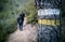 Hiking path mark over tree trunk with hikers