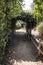 Hiking pathway with flowers archway in a park in French Riviera