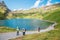Hiking people and Bachalpsee lake at Swiss Alps mountain Grindelwald First in Grindelwald, Switzerland