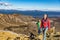 Hiking people hikers trekking on mountains in altitude trek. Couple tourists tramping in New Zealand during hike on