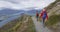 Hiking people in New Zealand on mountain top Roys Peak enjoying active lifestyle