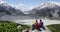 Hiking people sitting down enjoying looking at outstanding view of mountains