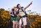 Hiking, pointing and excited couple in nature for adventure, holiday and journey on mountain. Travel, dating and man and