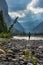 Hiking in the rain Woman Hiker crosses the Ghost River Trans Alta trail with Mt Aylmer in the background