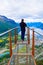 Hiking Rampestreken. Tourist man on the Rampestreken Viewpoin. Panoramic landscape Andalsnes city in Norway