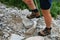 hiking shoes in action on a mountain desert trail path. Close-up of male hikers