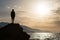 Hiking silhouette backpacker, man looking at ocean