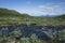 Hiking in Swedish Lapland. Man crossing river, Trekking  in Sweden in summer. Arctic nature